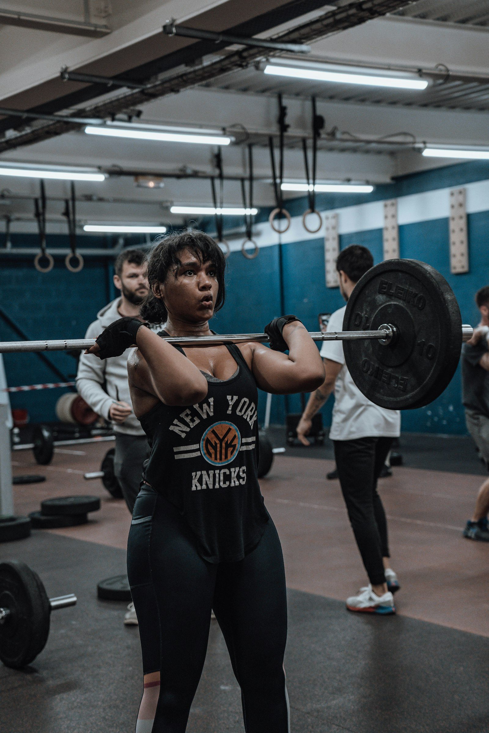 A lifter catching a barbell in the front-rack position